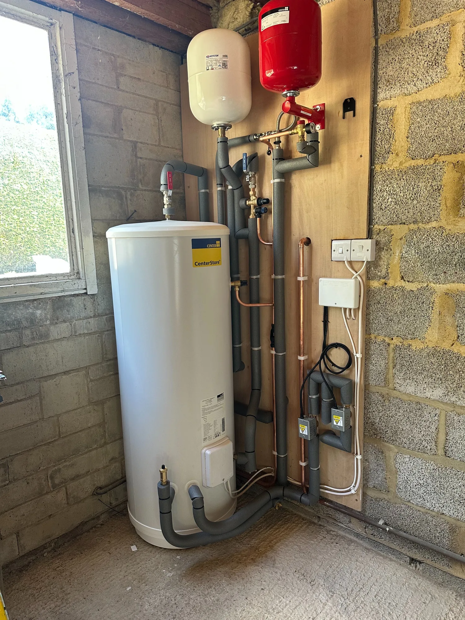 Unvented hot water cylinder installed by Heritage Heating Services, showing our attention to pipework detail